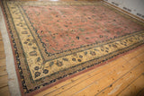 Vintage Mohajeran Sarouk carpet corner, ornate ivory border, dusty rose floral field, and full fringe.