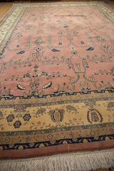 Hand-knotted Mohajeran Sarouk rug's ivory floral border, dusty rose field, and fringe.