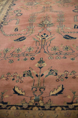 Close-up of dusty rose vintage Mohajeran Sarouk carpet with ornate floral branches and full pile.