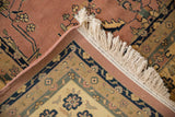 Mohajeran Sarouk carpet corner displaying dusty rose field, ivory fringe, and traditional floral border.
