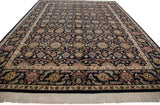 Agra carpet's dark field with intricate floral palmettes, serrated leaves, and fringed border.