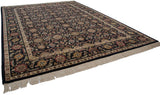 Corner of vintage Agra carpet, showing intact ivory fringe and black, gold, and red floral palmette border.