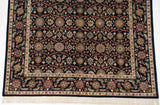 Vintage Agra carpet corner showing ivory fringe, intricate floral palmettes, and serrated leaf borders.
