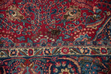 A small area of discoloration on the cherry red field of the vintage Tabriz carpet.