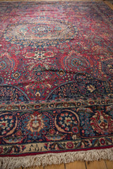 Close-up of the weaver's signature within the outer border of the vintage Tabriz rug.