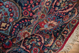 Detail of the vintage Tabriz rug's lotus flower border and plush hand-knotted pile.