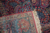 Hand-knotted construction and original ivory fringe on the corner of a vintage Persian Tabriz rug.
