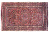 Oversize vintage Meshed carpet with a roundel medallion, botehs, and scrolling vinery in red and navy blue.