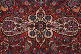 Finely knotted floral cross-section in sapphire blue and ivory on a vintage cherry red carpet.