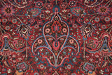 Fine weave showing a trefoil finial and floral arabesques in cherry red and sapphire blue.