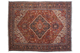 Vintage Bakshaish carpet with cherry red field, navy diamond medallion, palmettes, and intricate geometric floral design.
