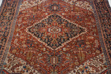 Intricate cherry red field with geometric leaves, blossoms, and pinwheel motifs of a Vintage Bakshaish carpet.