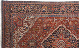 Vintage Bakshaish carpet showing detailed navy border and cherry red geometric field motifs.