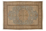 Vintage Tabriz carpet with a scalloped quatrefoil medallion on a powder blue field of floral blossoms.
