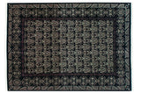 Vintage Indian Damask carpet with repeating floral motifs in ivory and aubergine on a black field.