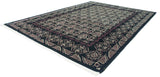 Angled corner view of the vintage carpet's plush pile and damask design border.