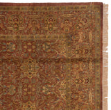 Vintage Indian Agra carpet's corner showing copper field, gold blossoms, olive border, and fringe.
