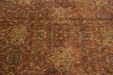 Copper and dusty gold field of the Agra carpet displays intricate floral vinery.
