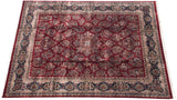 Cherry red floral field and navy shadow cartouche border corner on an Indian Sarouk rug.