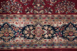Detailed shadow cartouche border of a Sarouk rug, in rich red and navy florals.