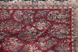 Indian American Sarouk design carpet showing deep black cherry red floral sprays and border.