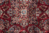 Dense traditional floral pattern with detailed buds and blossoms in cherry red, navy, and ivory.
