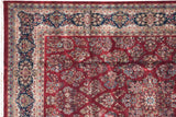 Curvilinear floral sprays and detailed blossoms on a deep red Indian Sarouk rug.