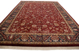 Rich wine red field of Mohajeran Sarouk design, displaying scrolling tendrils and a navy floral border.