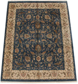Agra carpet's ivory border, detailed palmettes, vines on deep denim blue field.