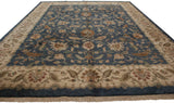 Ivory main border with meandering vine and floral motifs on the denim blue Agra carpet.