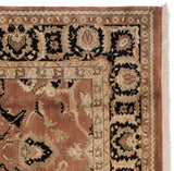 Corner of vintage Agra carpet, bronze field with black, ivory stylized floral borders.