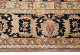 Agra carpet close-up: black field with flowing antique ivory, bronze arabesques, copper floral border.