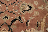 Agra carpet detail: bronze field with black, ivory, sage Safavid-inspired floral arabesques.