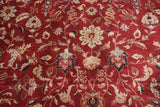 Detailed floral blossoms and scrolling tendrils in ivory and slate blue on a wine red pile.