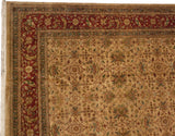 Corner view of an Agra carpet with a burgundy floral border and golden lattice field.
