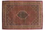 Vintage Indian Bijar design carpet with a black hexagonal medallion on a wine-red field with Herati motifs.