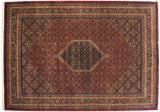Corner detail of a fine Indian Bijar carpet with intricate floral borders and clean ivory fringe.
