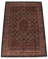 Detailed borders and dense burgundy Herati style floral field of Indian Bijar carpet.