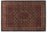 Upper corner of Indian Bijar rug, displaying wine red borders and Herati mahi-mahi motif.