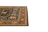 Corner angle showing the intact selvage and brick red floral border of the Indian carpet.