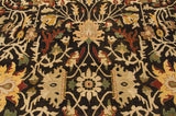 Angled view of the soft wool pile showing floral palmettes on a dark chocolate brown field.