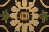 A large-scale floral palmette in beige and green with a red center on soft wool pile.