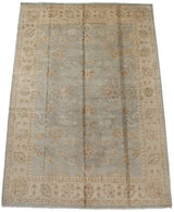 Powder blue field with bronze serrated palmettes and delicate vinery details on the Oushak rug.