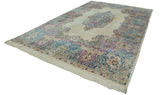 Vintage Kerman carpet's intact ivory fringe with Rococo floral motifs in blue and pink.
