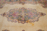 Vintage Kerman carpet: Rococo stylized medallion, blossomed floral sprays in pink, blue, and ivory.