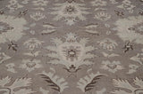 Intricate hand-knotted floral vinery in ivory, silver, and oxidized silver tones.
