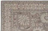 Detail of the Indian Northwest Persian carpet's corner, with oxidized silver and ivory floral palmettes.