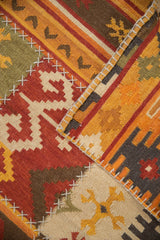 Textured geometric panels joined by simulated cross-stitch seams on a patchwork kilim rug.