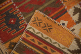 Warm-toned geometric kilim patchwork panel, showing raised cross-hatch simulated seams.