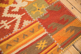 Fragmented geometric patchwork Kilim panel with simulated white cross-stitch seams.